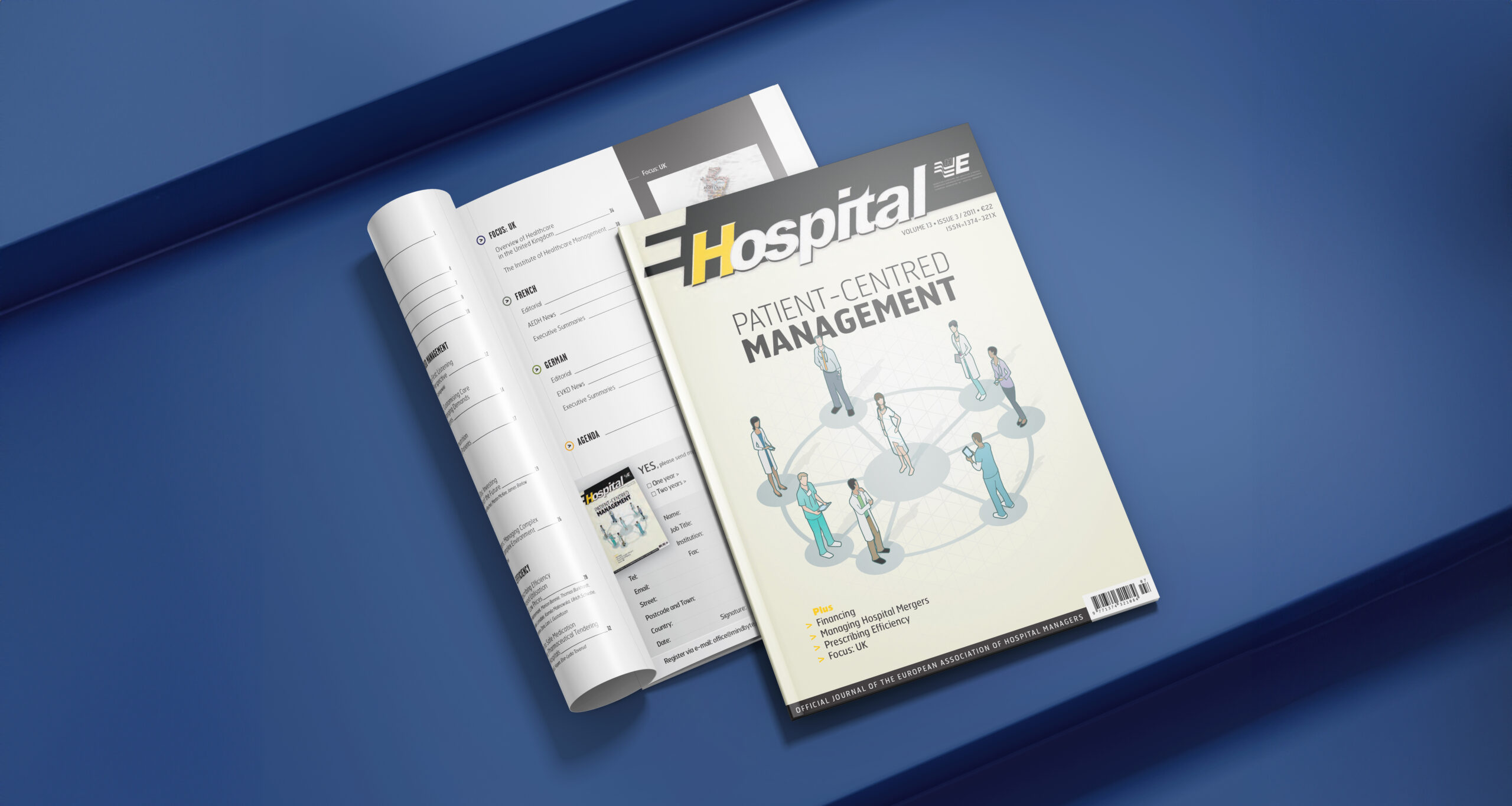 Two health care management magazines on blue surface